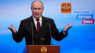Wladimir Putin hält eine Rede an einem Mikrofon