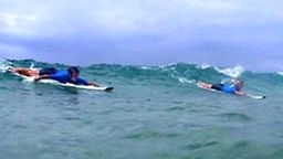 Surfcamp - Zwei Surfer nehmen eine grüne Welle