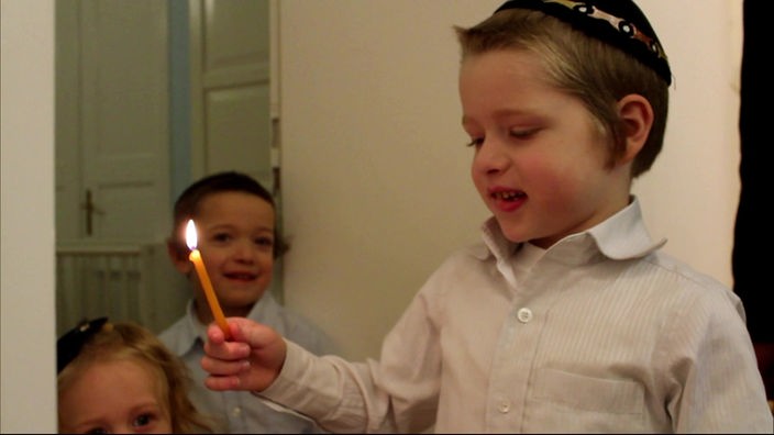 Shmuel hat eine Kerze in der Hand