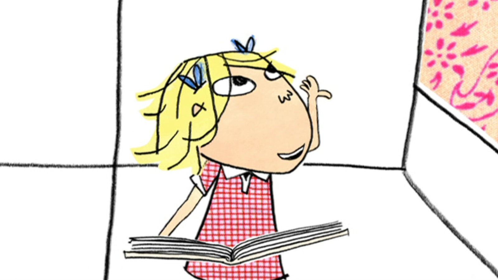 Lola schaut mit einem Buch auf dem Schoß in die Luft