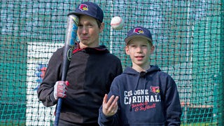 Johannes und Chris stehen in Baseball-Outfit nebeneinander.