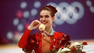 Katharina Witt mit Goldmedaille und Blumen bei den Olympischen Winterspielen 1988.
