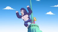 Ein Mann im King-Kong-Kostüm und die entführte Pamela auf dem dach eines Hochhauses