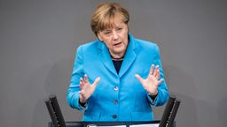 Angela Merkel am Rednerpult im Bundestag.
