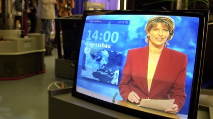 Fernsehbildschirm zeigt Tagesschau mit Moderatorin Susanne Holst.