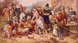 Englische Siedler in den USA  bewirten eine Gruppe Indianer.