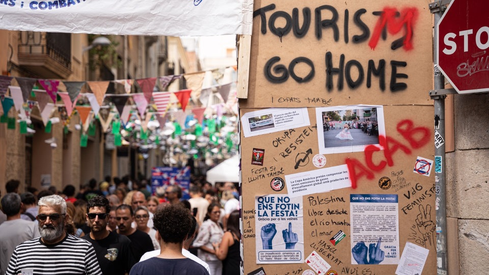 Aufschrift "Tourists go home" auf einer Hauswand in Barcelona.