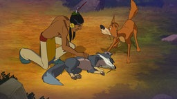 Ein Indianer findet auf der Erde im Wald einen Wolf.